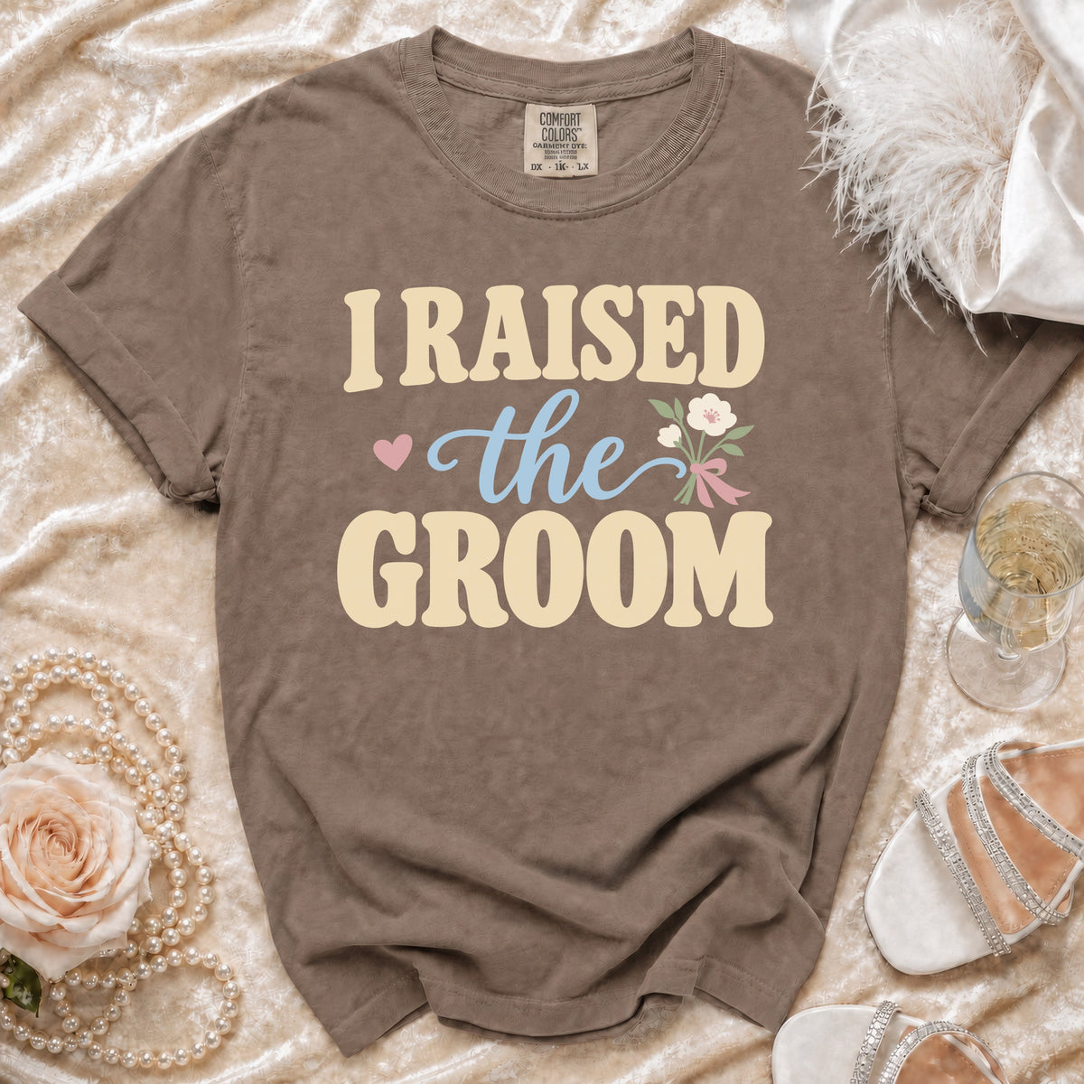 Brown t-shirt with "I RAISED the GROOM" text and floral graphic.