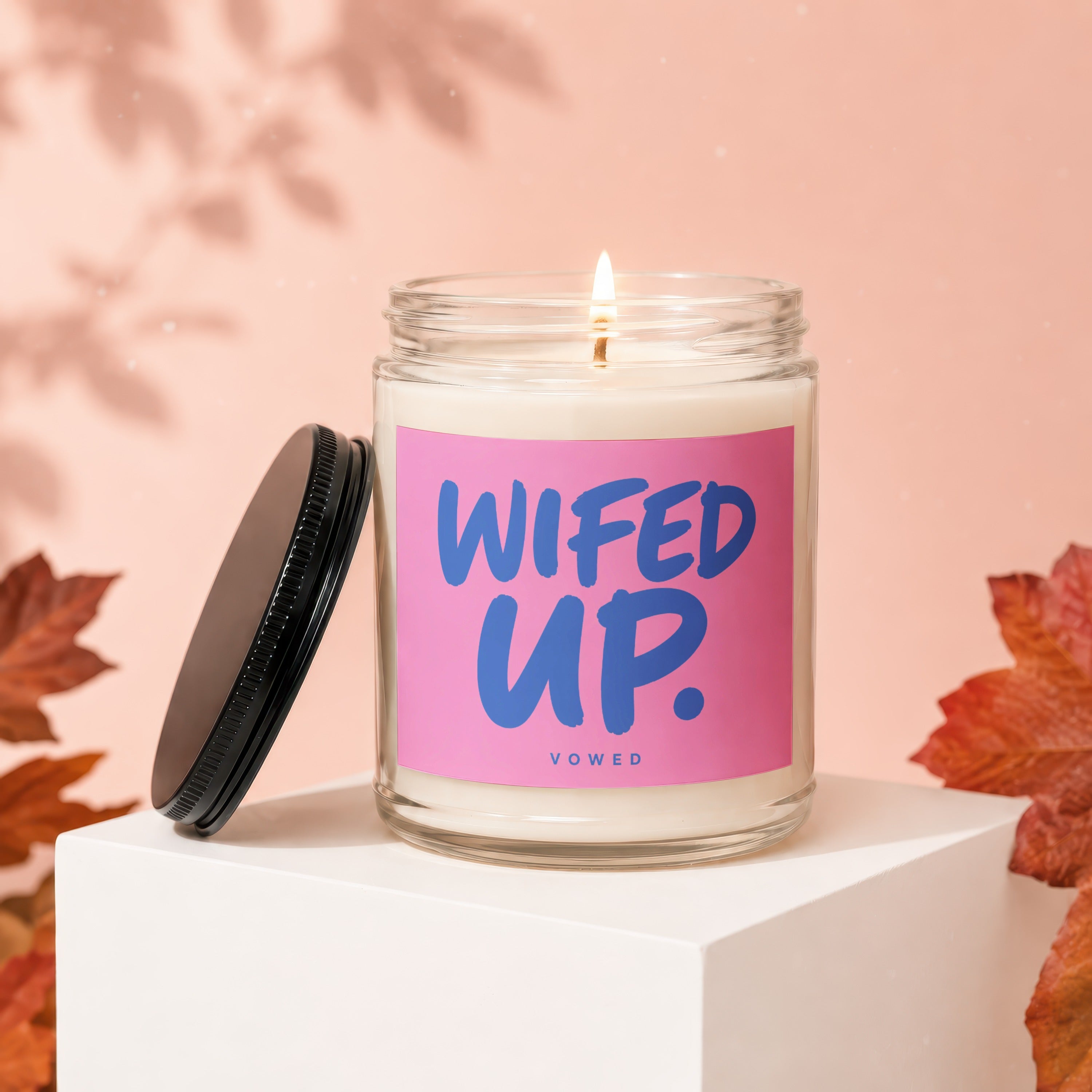 Candle with pink label reading "WIFED UP." and "VOWED" below.