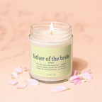 Glass jar candle with "father of the bride" definition and "vowed" text.