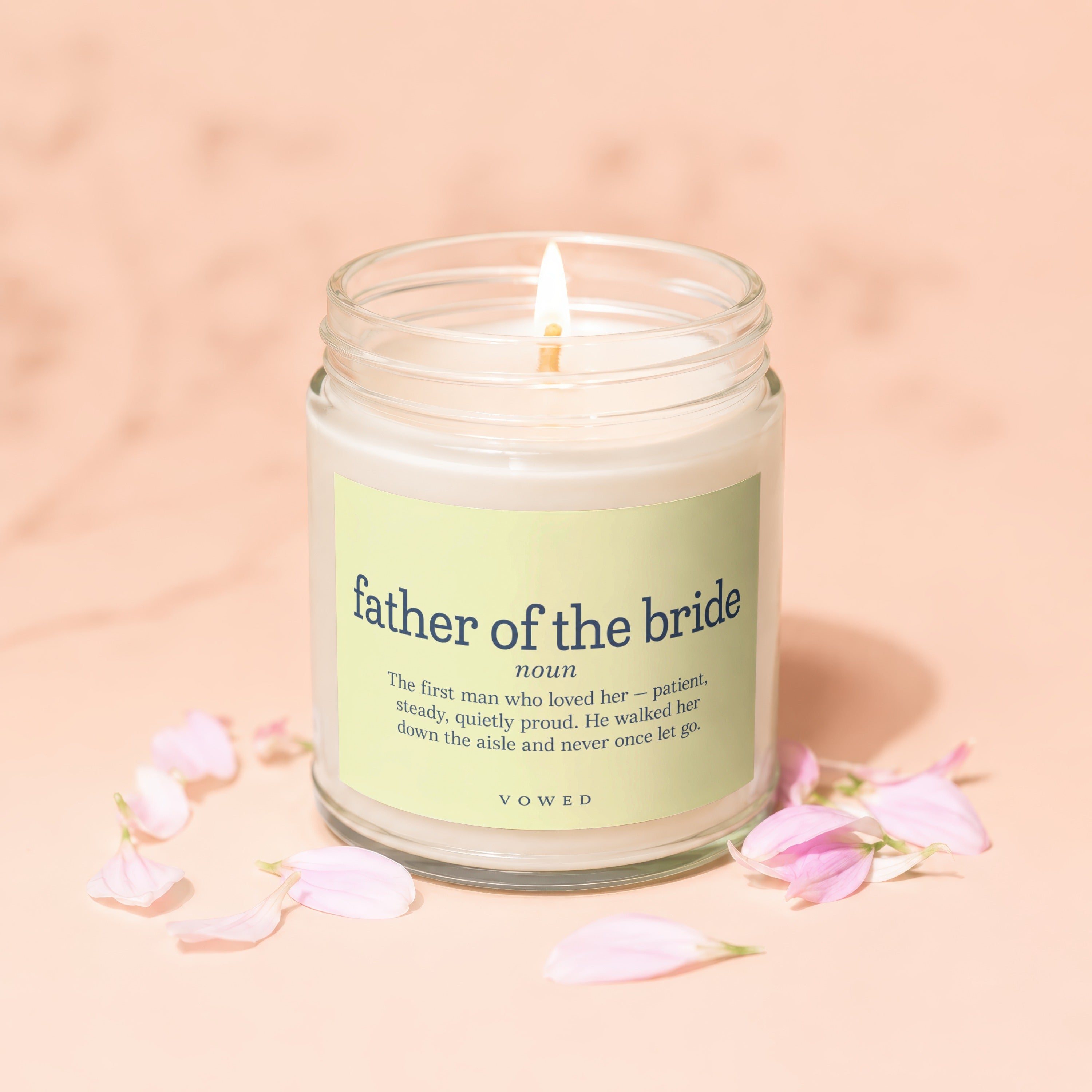 Glass jar candle with "father of the bride" definition and "vowed" text.