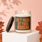 Jar candle with lit wick and "SH*T FACED AT YOUR WEDDING" label.