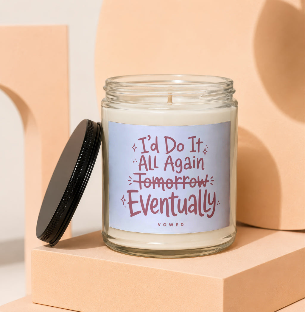Glass candle with black lid featuring text "I'd Do It All Again Tomorrow Eventually VOWED".