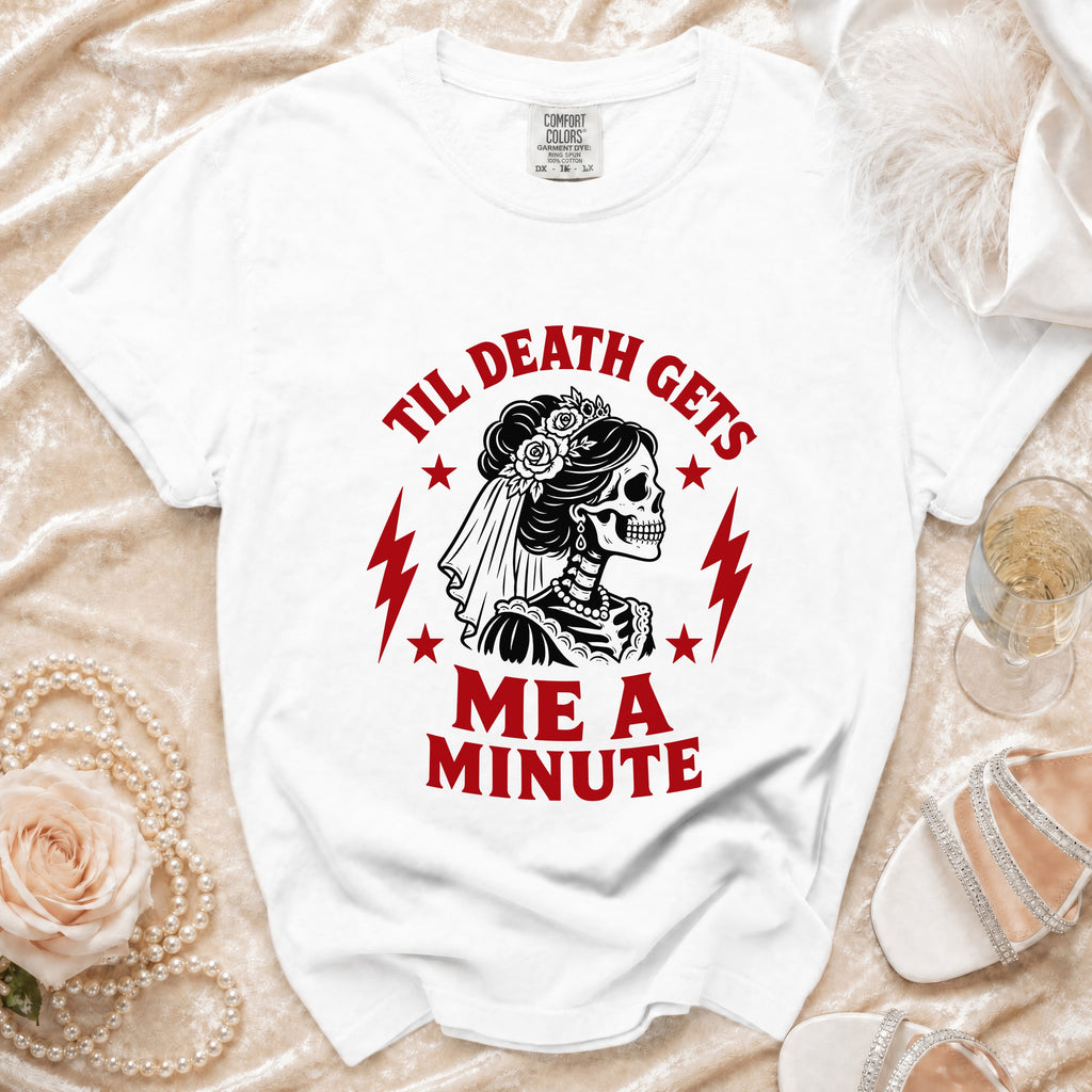 White t-shirt with "Til Death Gets Me A Minute" text and skeleton bride graphic.