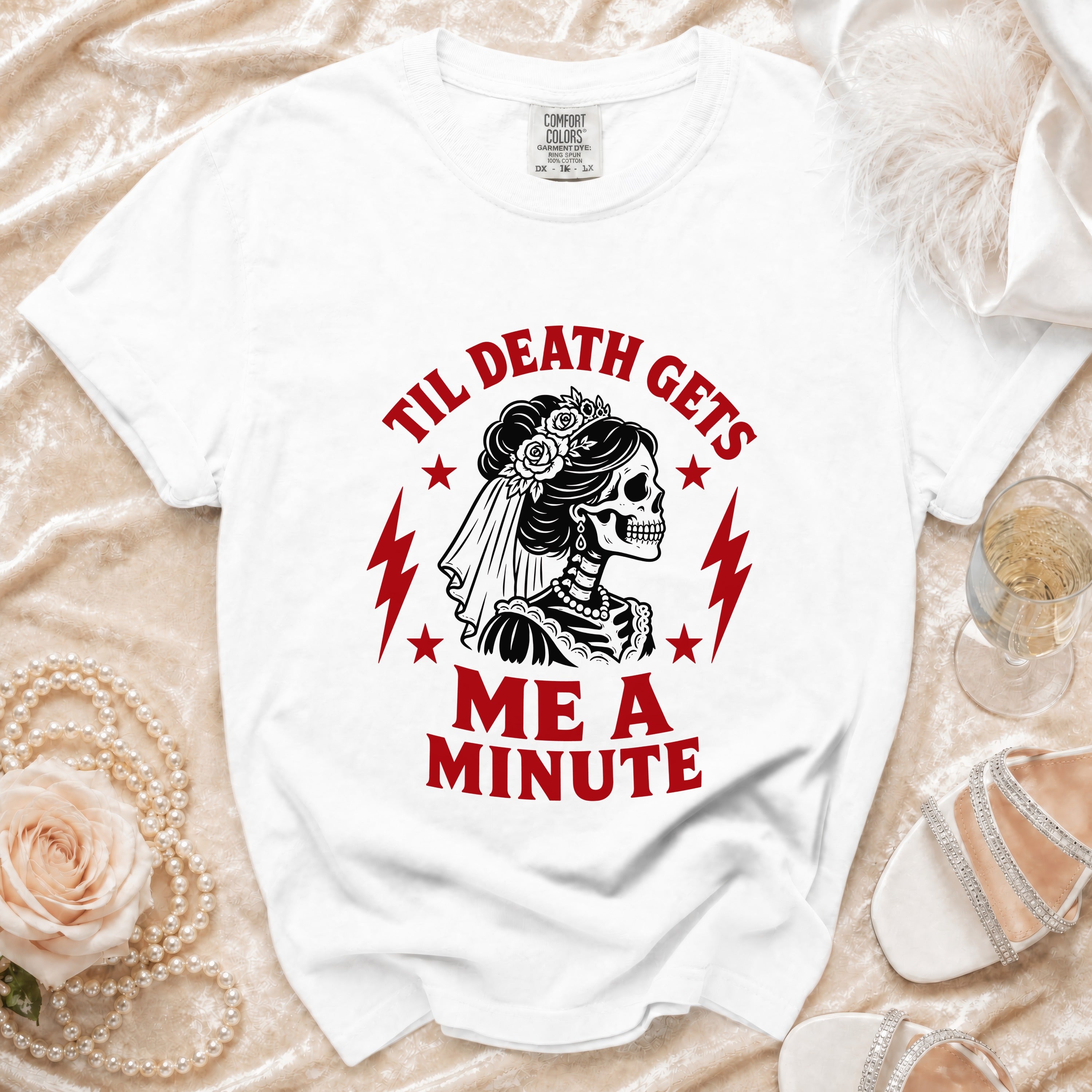 White t-shirt with "Til Death Gets Me A Minute" text and skeleton bride graphic.