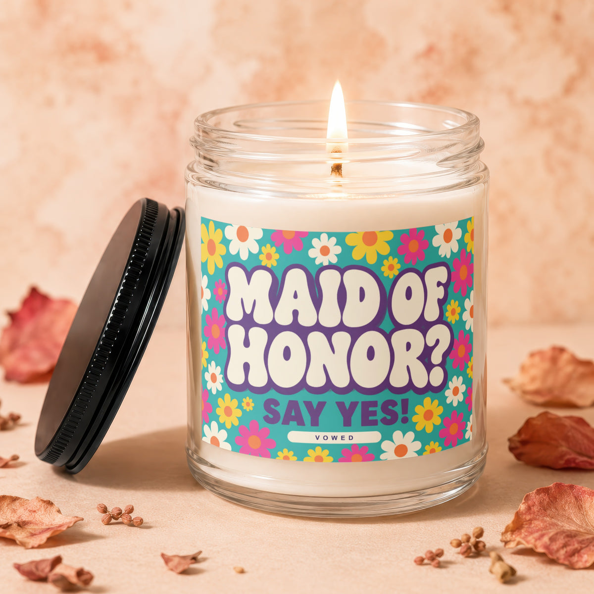 Candle with "Maid of Honor? Say Yes!" text on floral label, lid removed