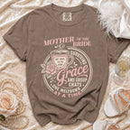 Brown t-shirt with "Mother of the Bride Surviving Grace and Group Chats" graphic.
