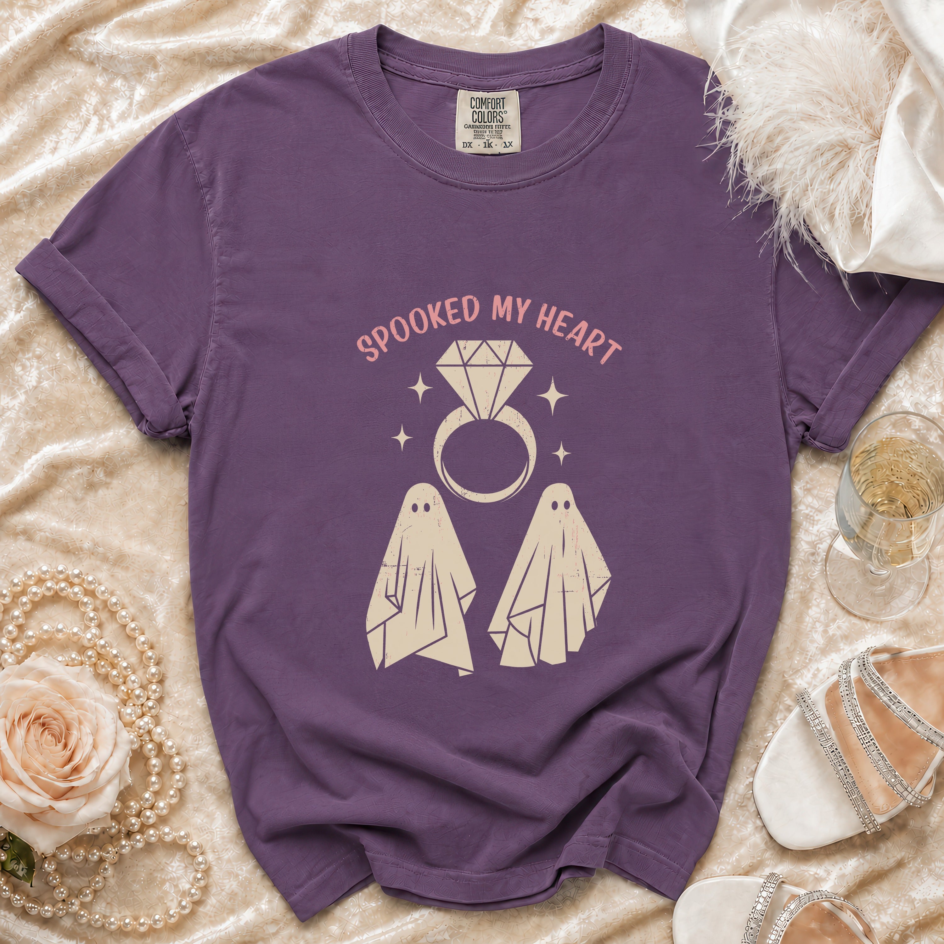 Purple t-shirt with "Spooked My Heart" text and two ghosts and ring graphic.