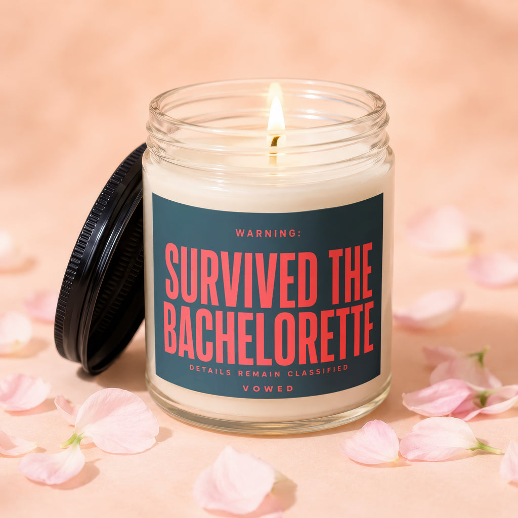 Lit candle with a lid off, reading "SURVIVED THE BACHELORETTE" in red text.