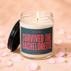 Lit candle with a lid off, reading "SURVIVED THE BACHELORETTE" in red text.