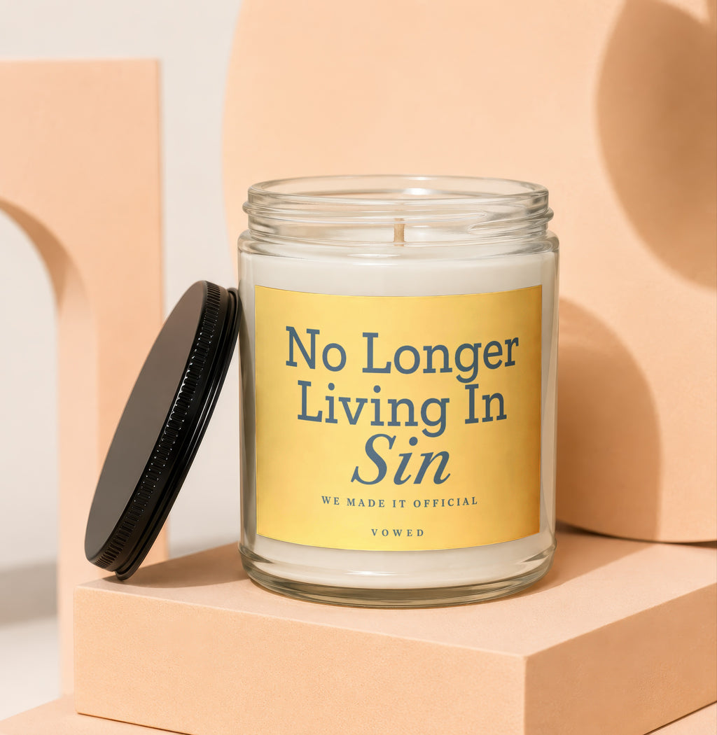 Glass candle with lid askew, inscribed "No Longer Living In Sin".