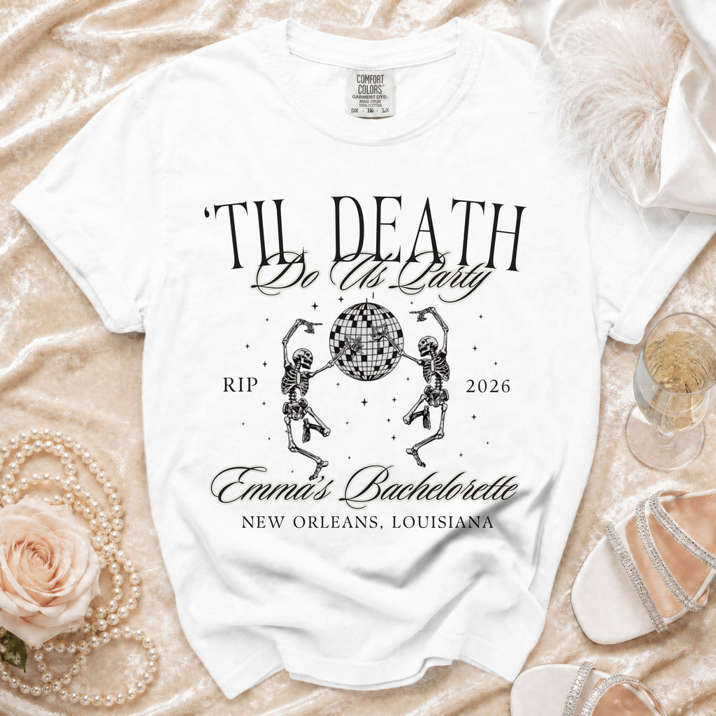 White t-shirt with "Til Death Do Us Party" graphic, skeletons, disco ball, and "Emma's Bachelorette."