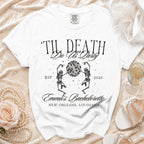 White t-shirt with "Til Death Do Us Party" graphic, skeletons, disco ball, and "Emma's Bachelorette."