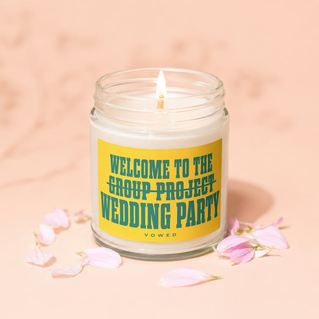 Candle with "Welcome to the Group Project Wedding Party" text, surrounded by petals.