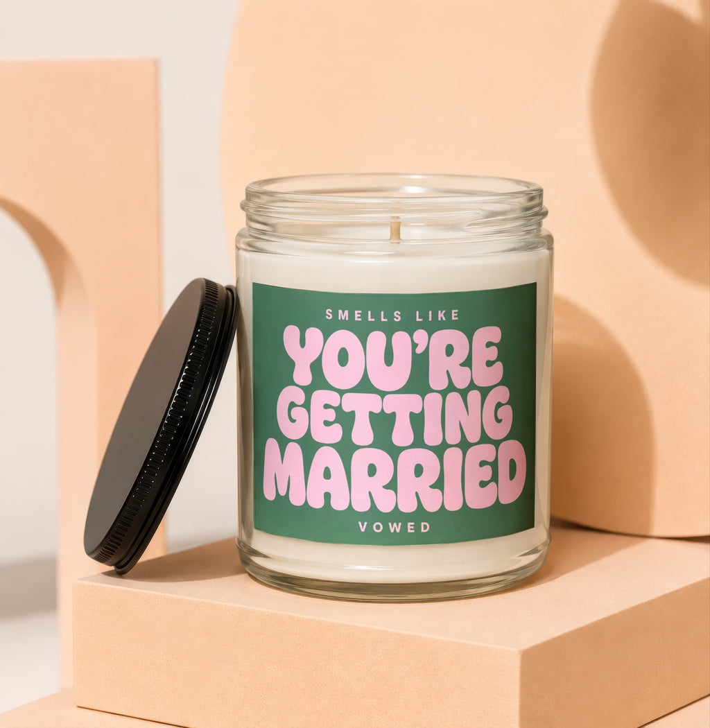 Scented candle with green label reading "Smells Like You're Getting Married"