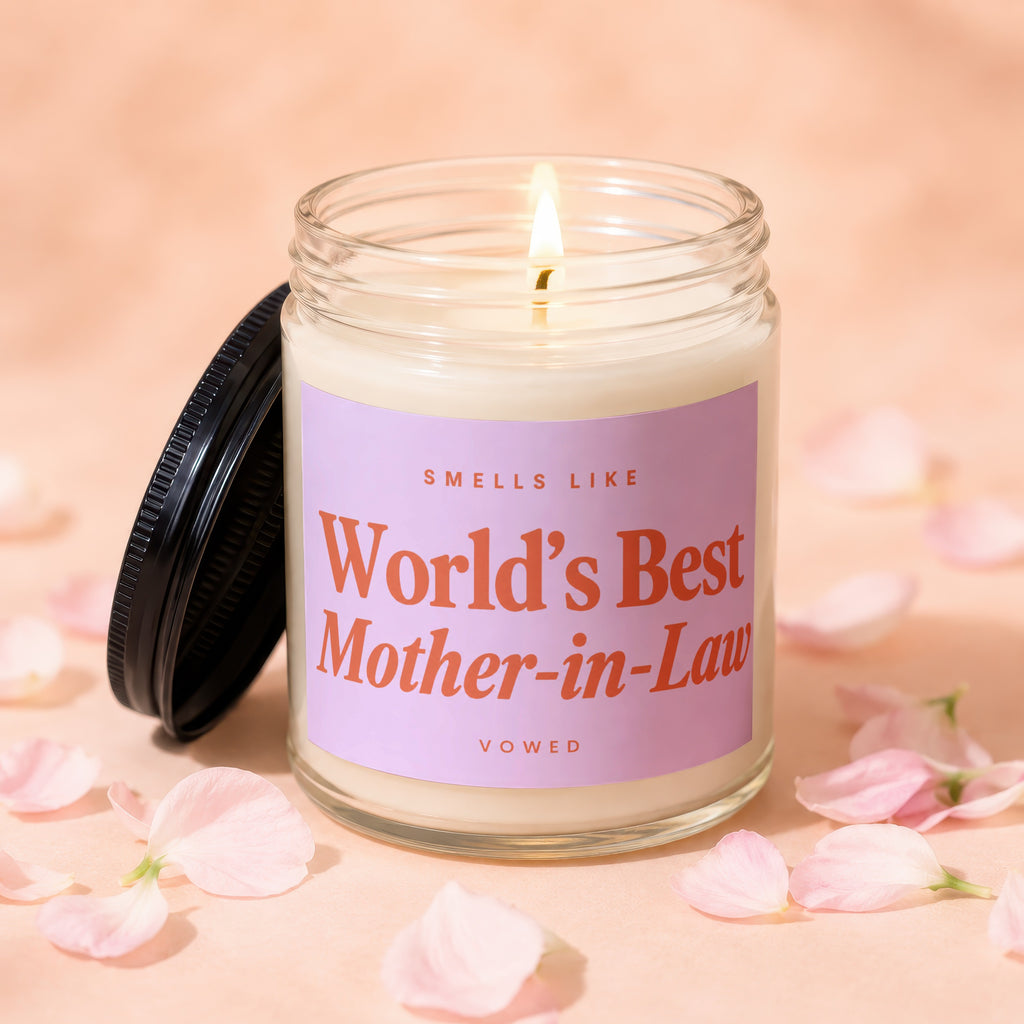 Lit candle with "World's Best Mother-in-Law" text on a pink label.