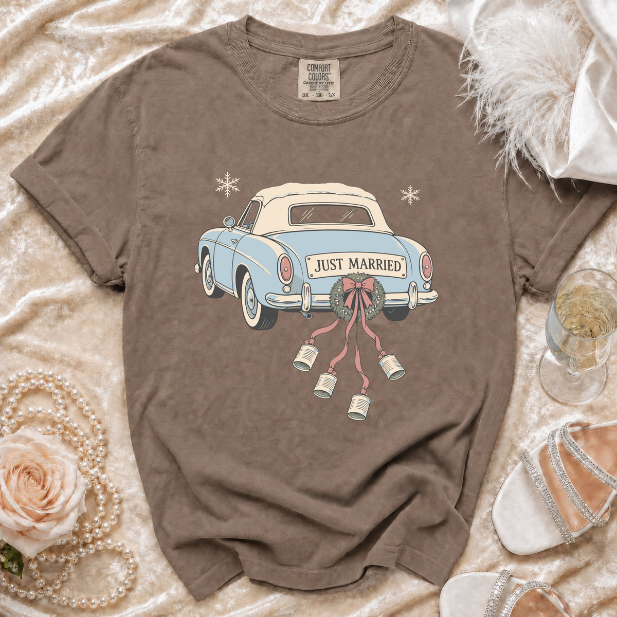 Brown t-shirt with a blue "JUST MARRIED" car graphic and snowflakes.