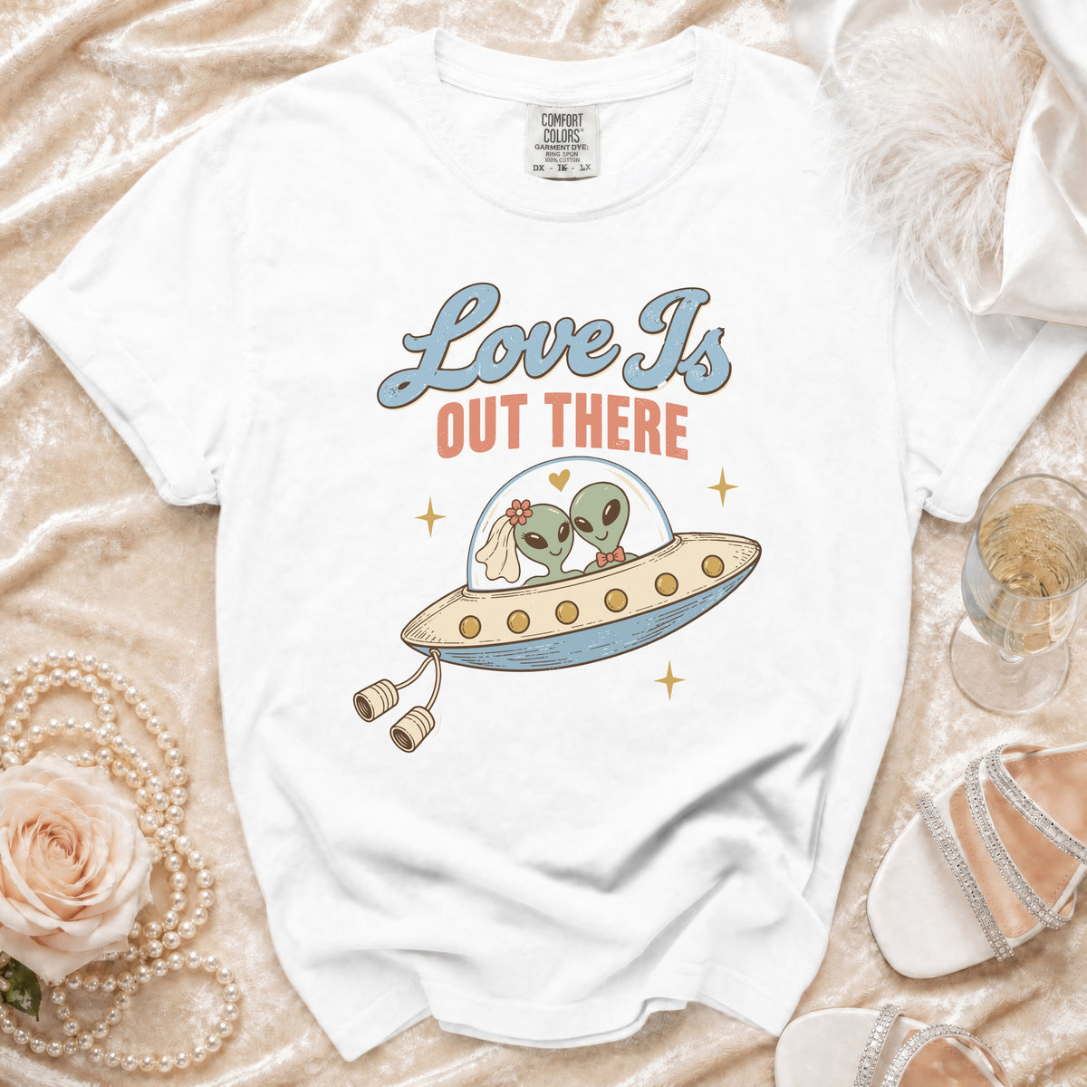 White t-shirt with aliens in a UFO, text "Love Is OUT THERE".