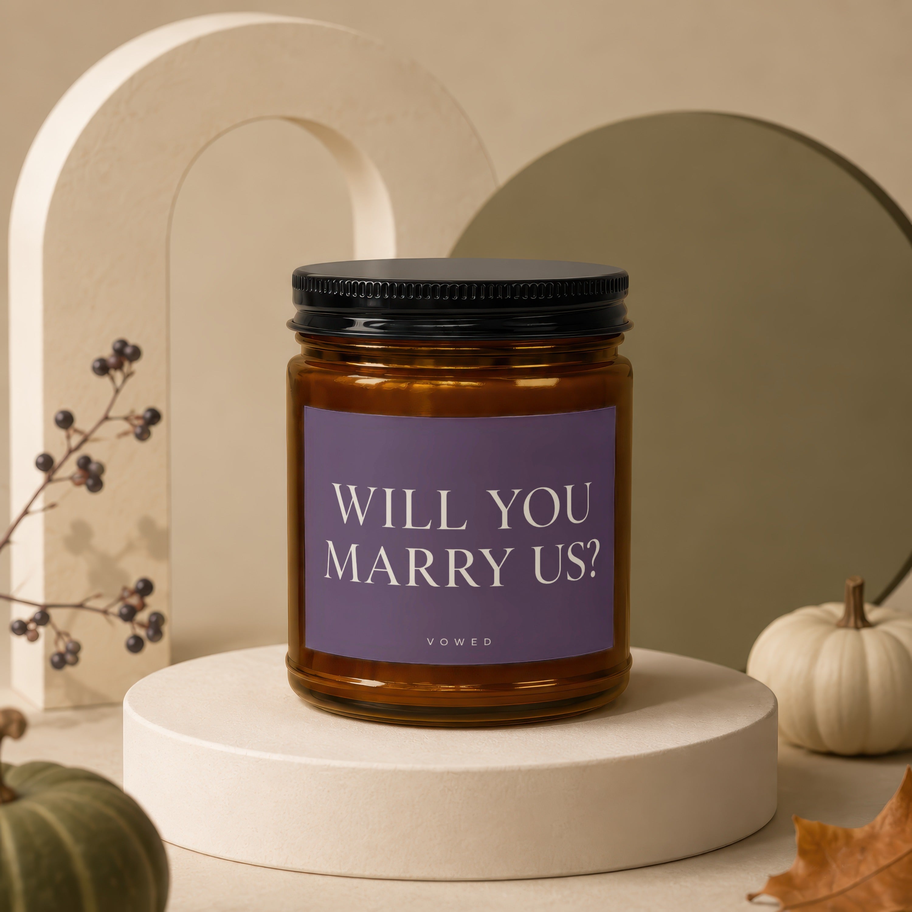 Amber candle with "WILL YOU MARRY US?" text on purple label.