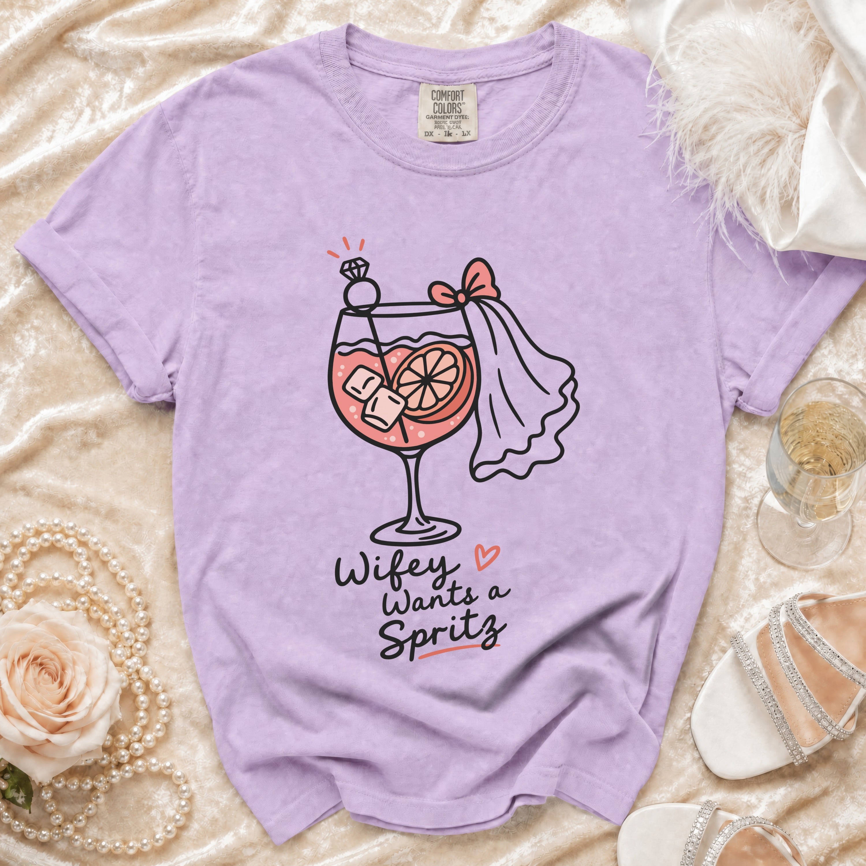 Lilac t-shirt with graphic "Wifey Wants a Spritz" and cocktail illustration.