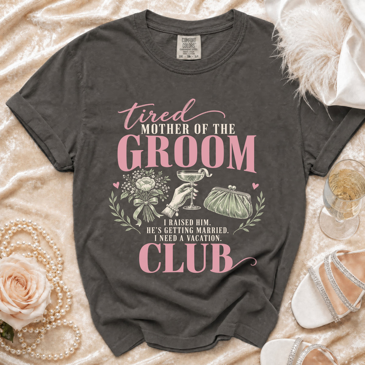 T-shirt with "tired MOTHER OF THE GROOM" and "CLUB" text, 12 words.