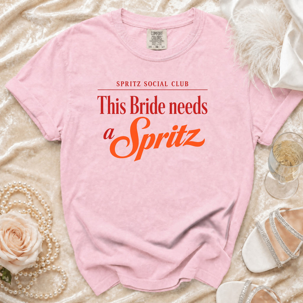 Pink t-shirt that reads "Spritz Social Club This Bride needs a Spritz".