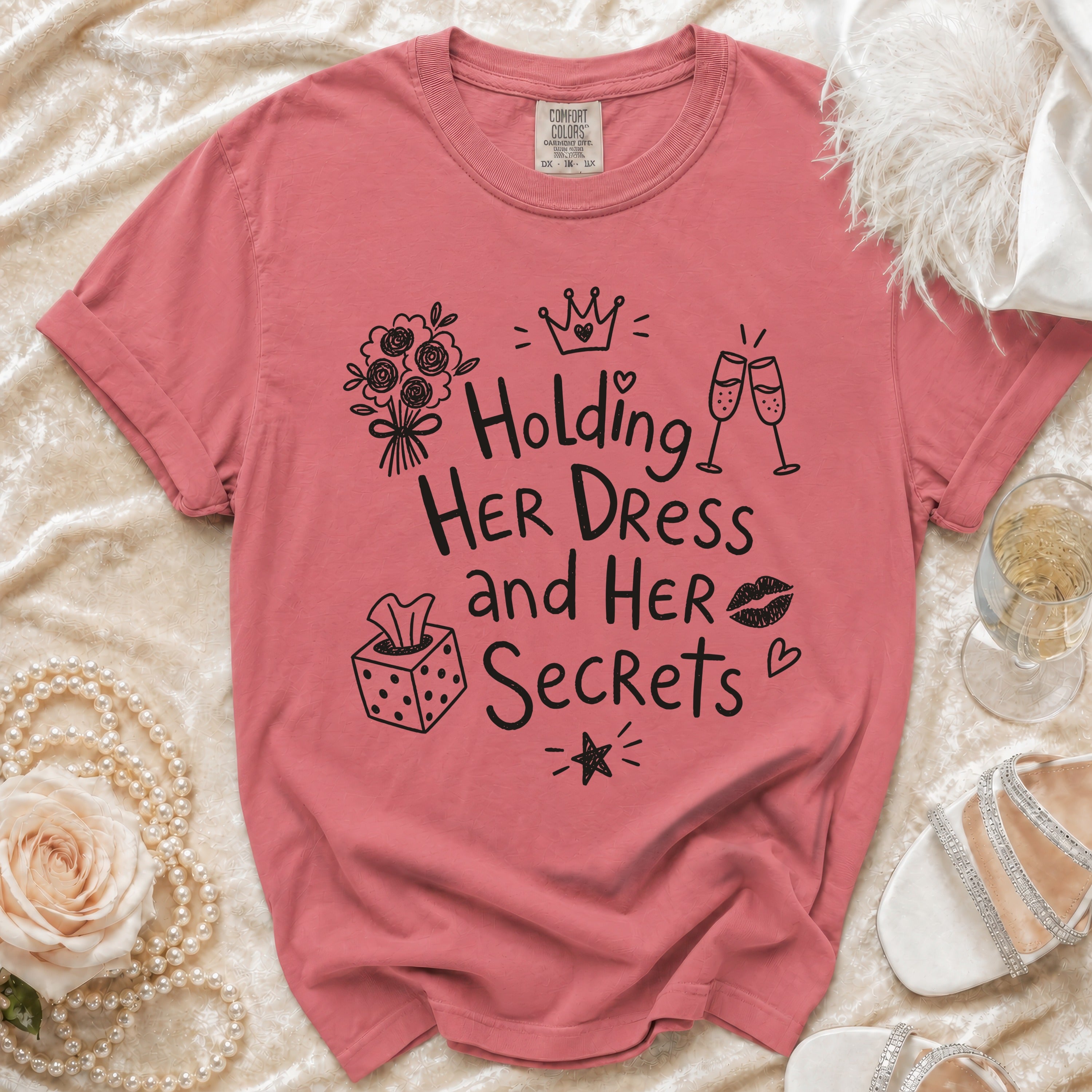 Pink t-shirt with "Holding HER DRESS and HER Secrets" text and doodles.
