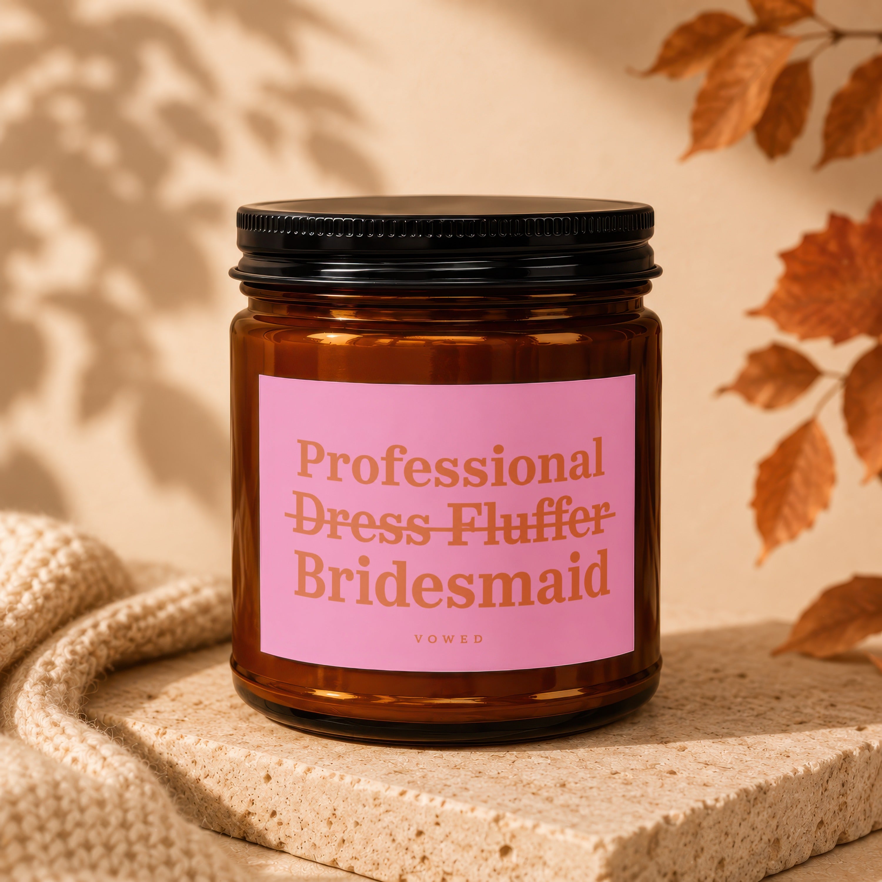 Amber candle with pink label reading "Professional Dress Fluffer Bridesmaid VOWED".