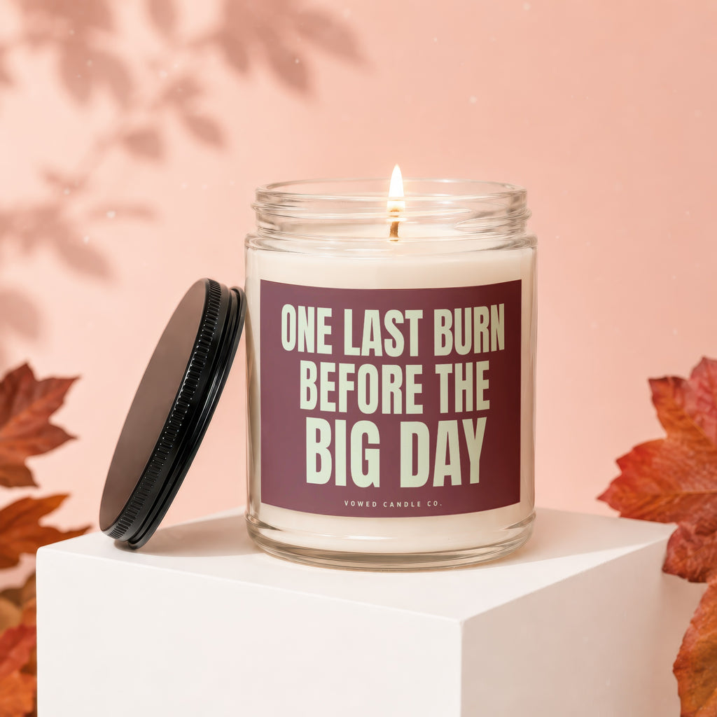 Glass candle with lid off reads "ONE LAST BURN BEFORE THE BIG DAY".