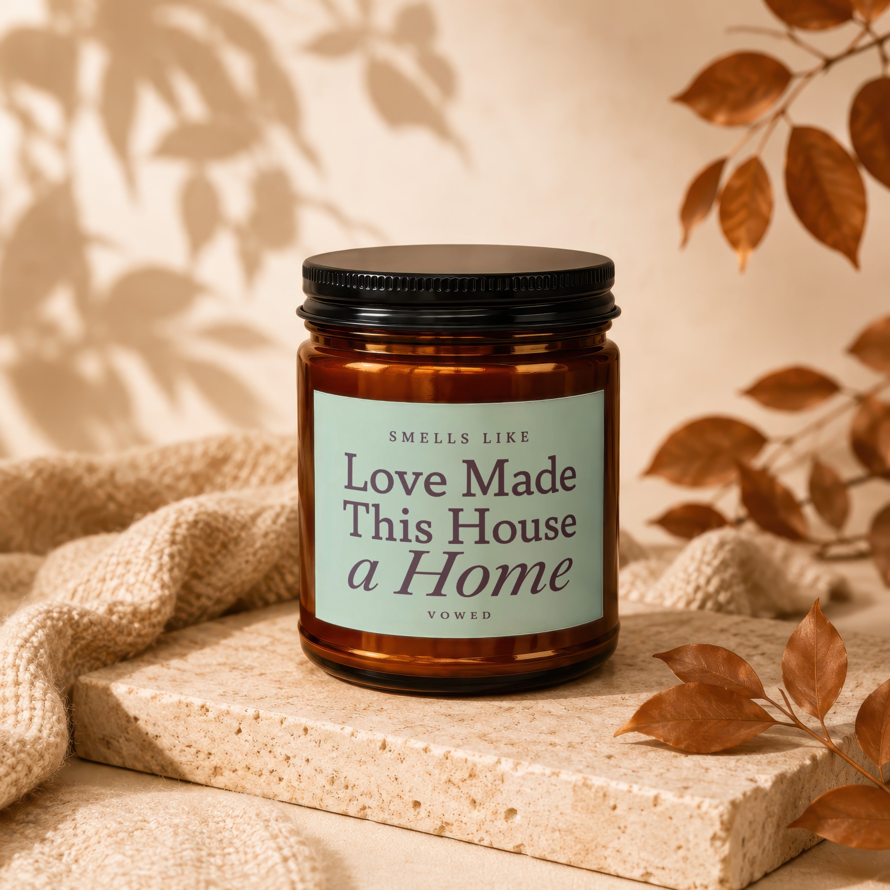 Amber jar candle with label "Love Made This House a Home" on display.