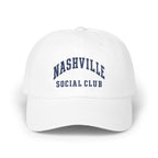 A white baseball cap with navy blue embroidered text reading NASHVILLE SOCIAL CLUB on the front panel.