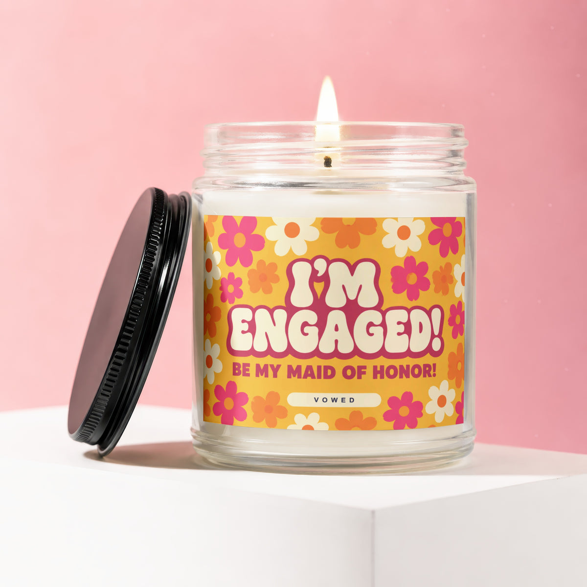 Candle with "I'm Engaged! Be My Maid of Honor!" text and floral pattern.
