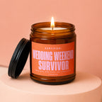 Amber jar candle with orange label reading "Wedding Weekend Survivor"