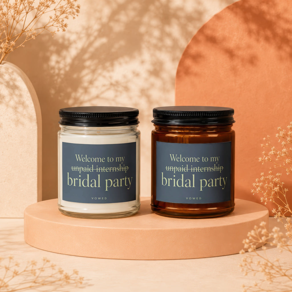 Two candles labeled "Welcome to my unpaid internship bridal party" by Vowed.
