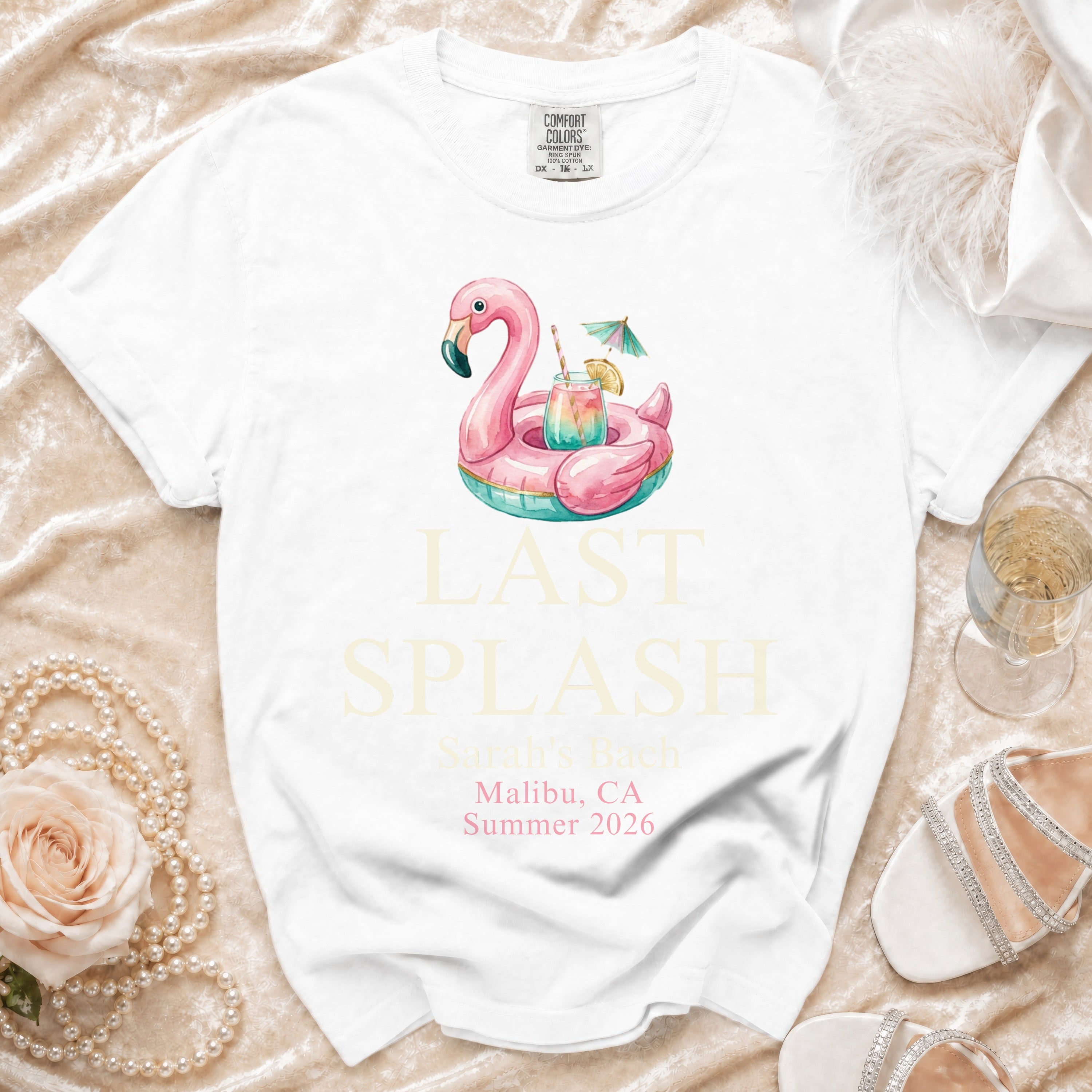 White t-shirt with flamingo float and "Last Splash Sarah's Bach" text.
