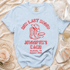 Light blue t-shirt with "Her Last Rodeo" text, boots, hat, and "Jennifer's Bach" details.
