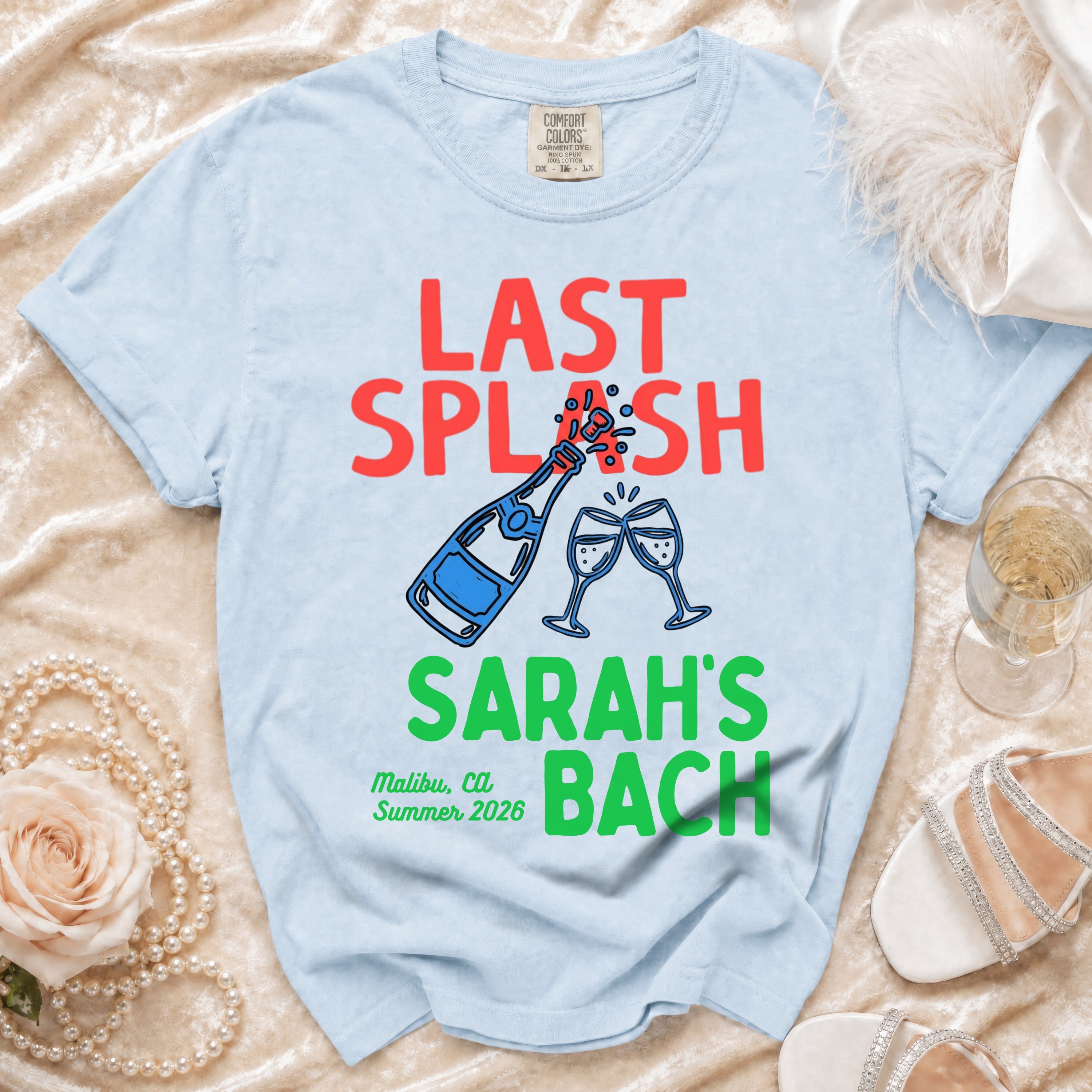 Light blue t-shirt with "LAST SPLASH SARAH'S BACH" and champagne graphic.