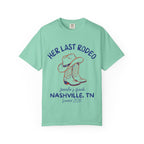 Teal t-shirt with cowboy boots and text "Her Last Rodeo" and bachelorette details.