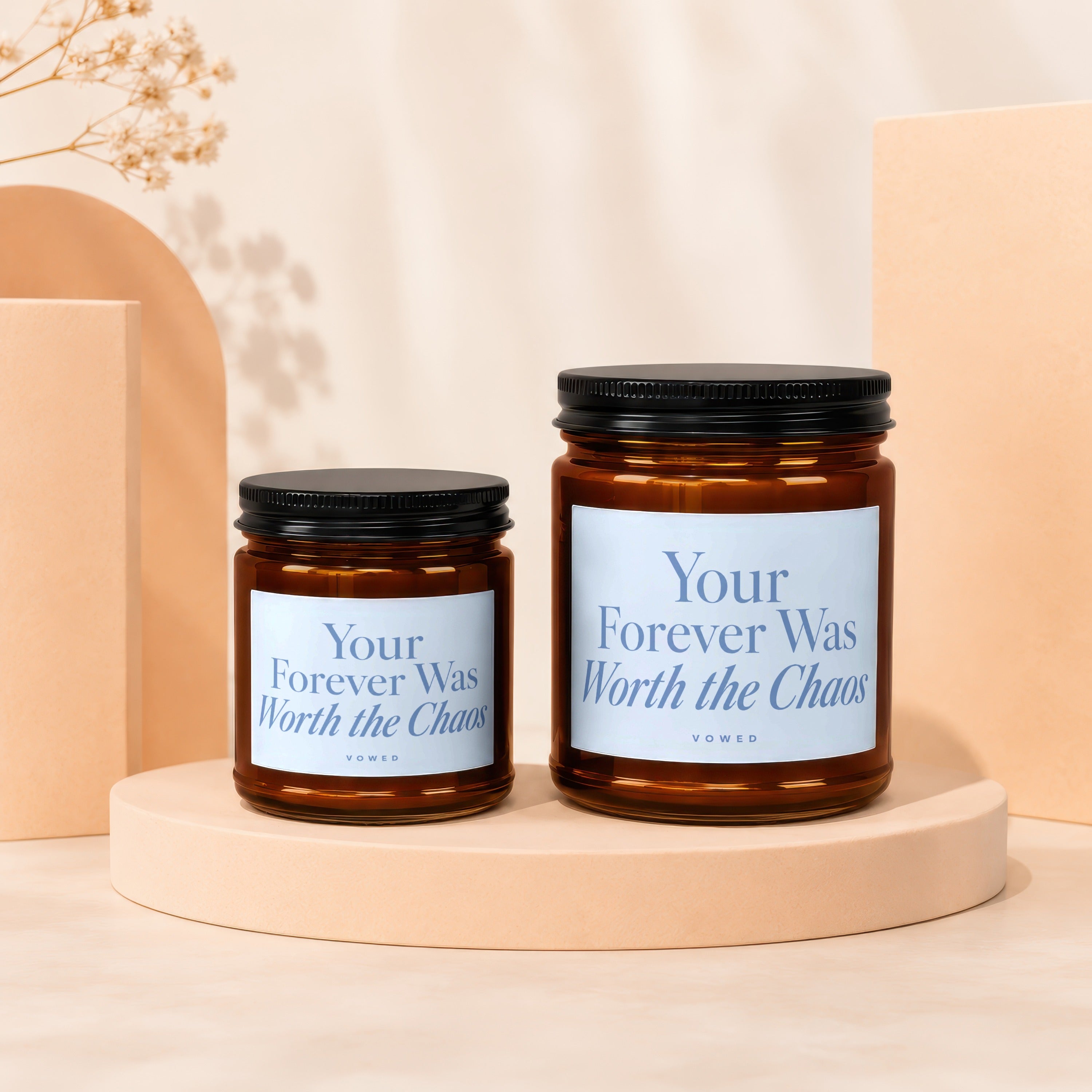 Two amber glass candles with black lids, labels read "Your Forever Was Worth the Chaos".