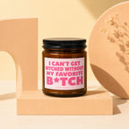 Brown glass candle with pink label reading "I CAN'T GET HITCHED WITHOUT MY FAVORITE B*TCH VOWED CANDLE CO."