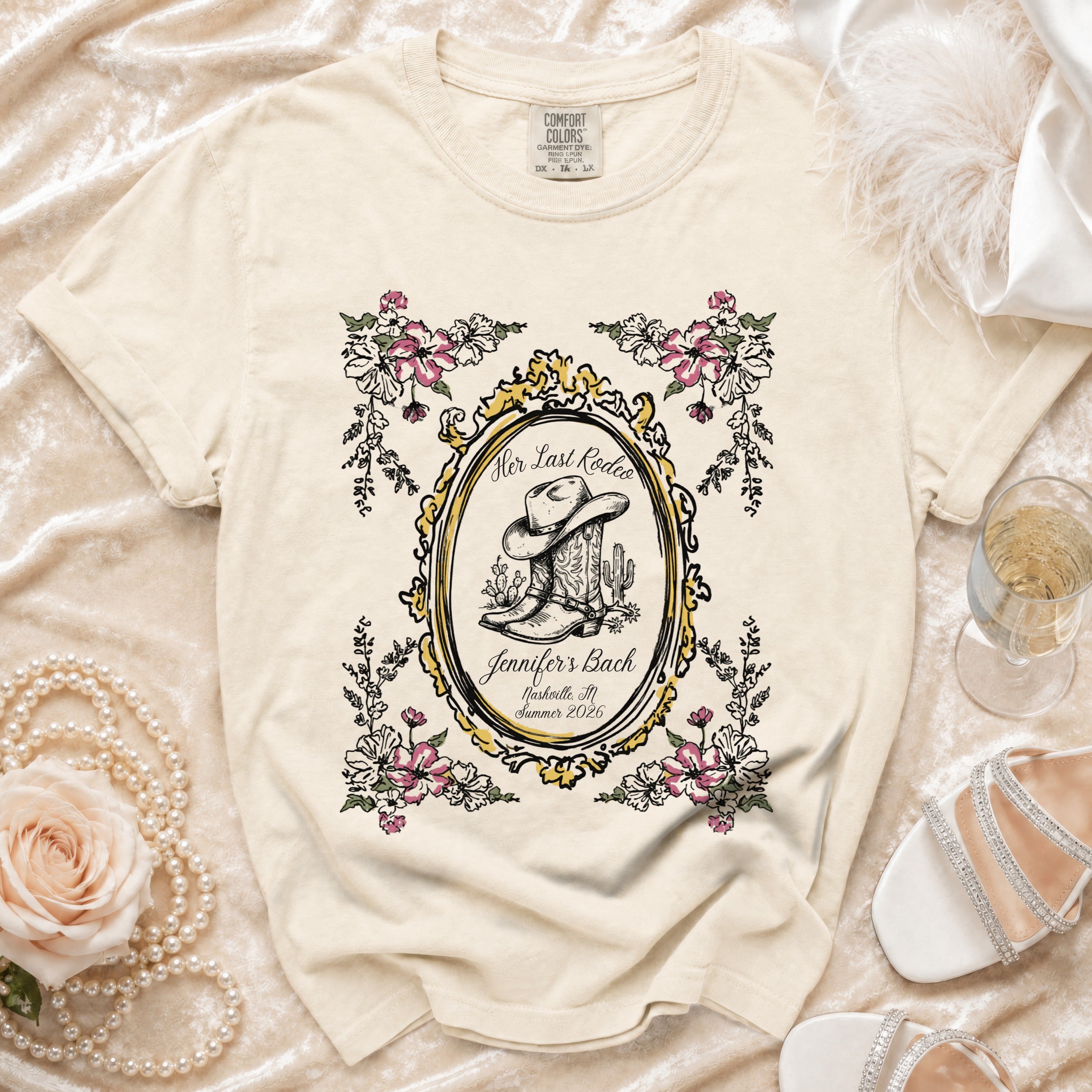 Cream t-shirt with "Her Last Rodeo Jennifer's Bach" and cowboy boot graphic.