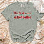 Light green t-shirt with red text "This Bride needs an Iced Coffee".