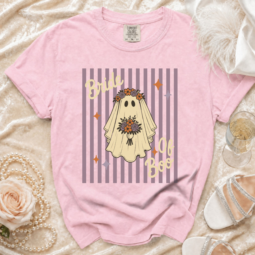 Pink t-shirt with ghost graphic reading "Bride of Boo" on striped background.