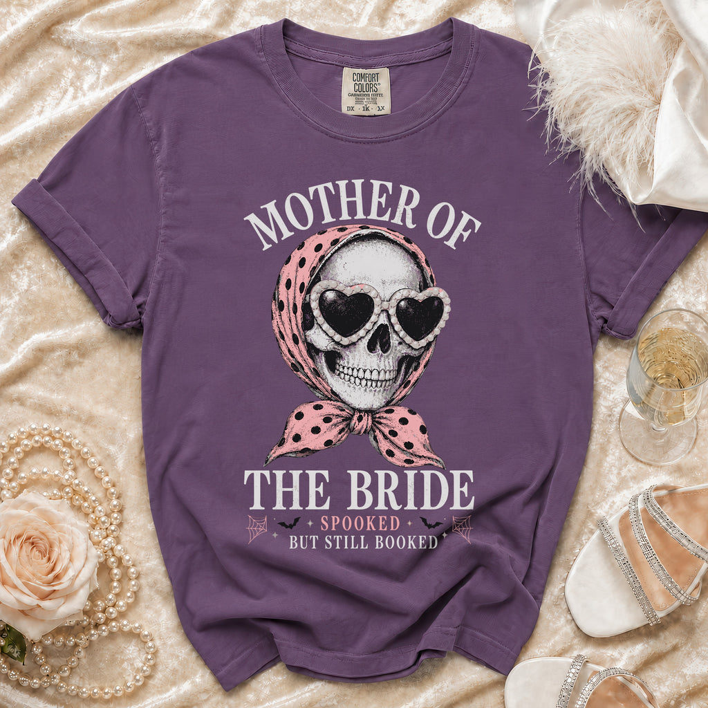 Purple t-shirt with skull wearing heart sunglasses and bandana, text: Mother of the Bride, Spooked But Still Booked.