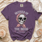 Purple t-shirt with skull wearing heart sunglasses and bandana, text: Mother of the Bride, Spooked But Still Booked.