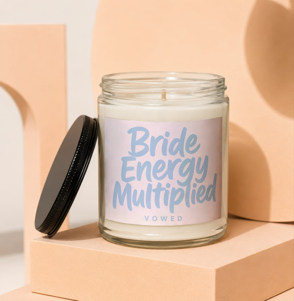 Glass candle with "Bride Energy Multiplied" and "VOWED" text on label.