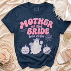 Navy Comfort Colors shirt with pink "Mother of the Bride boo crew" graphic and Halloween motifs.