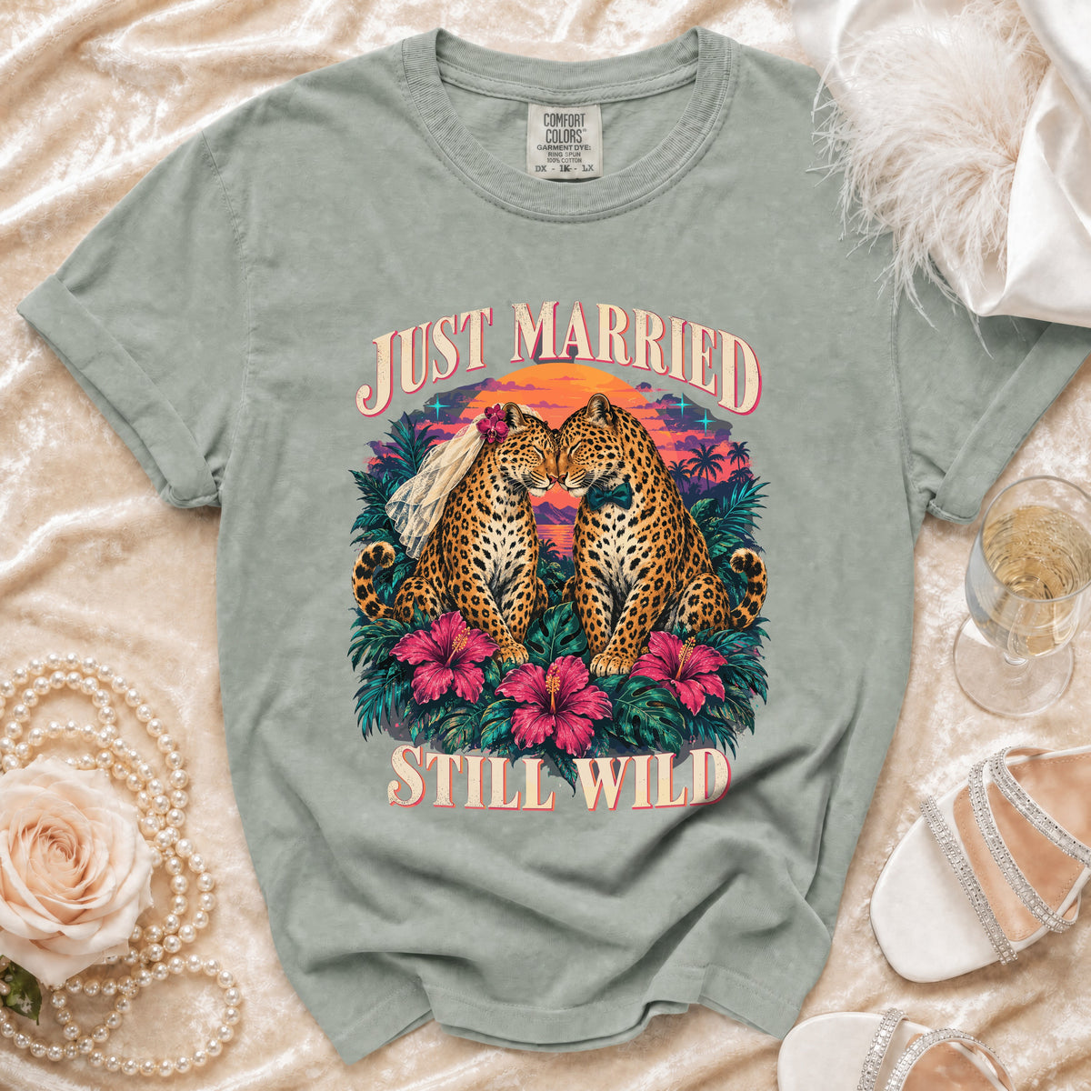 Light green t-shirt with "Just Married Still Wild" graphic of leopards at sunset.
