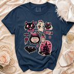 Navy t-shirt with gothic Halloween-themed graphic featuring cats, ghost, bat, and haunted house.