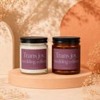 "Trans joy, wedding edition" candles in clear and amber jars.