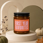 Amber jar candle labeled "First Year Favorites" with "Vowed" below.